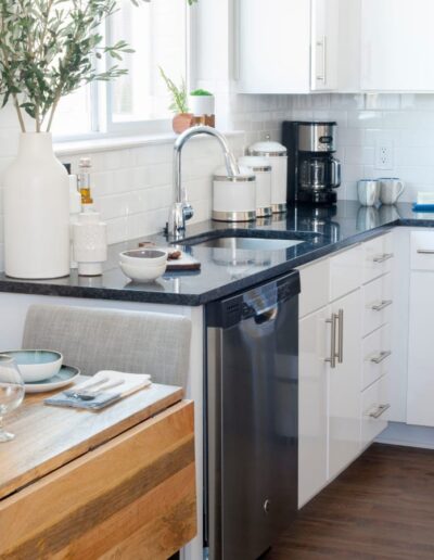 Kitchen Showcasing White Cabinets & Stainless Steel Dishwasher